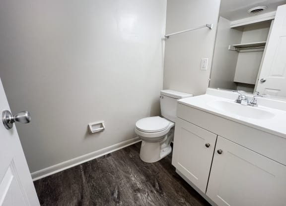 a bathroom with a toilet sink and mirror at Wentworth Estates Apartments, Florence, KY