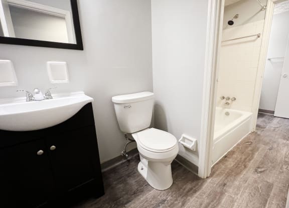 a bathroom with a toilet sink and bathtub  at Summit East - A Senior Community, Ohio, 45237