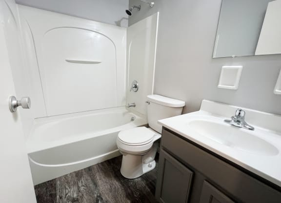 a bathroom with a toilet sink and bathtub  at Summit East - A Senior Community, Ohio, 45237