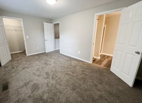 a bedroom with two closets and a door to a bathroom  at Woodhills Apartments, Ohio