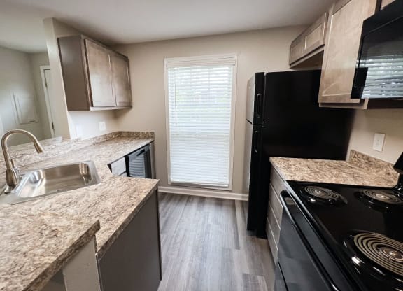 a kitchen at the acadia park apartments in houma, la  at Woodhills Apartments, West Carrollton, OH, 45449