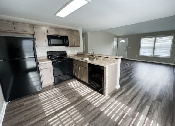 an open floor plan with a kitchen and living room  at Woodhills Apartments, West Carrollton, 45449