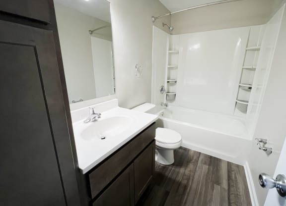 a bathroom with a sink toilet and bathtub  at Woodhills Apartments, West Carrollton, 45449