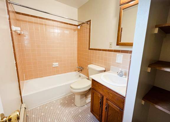 A bathroom with a toilet, sink, and bathtub.