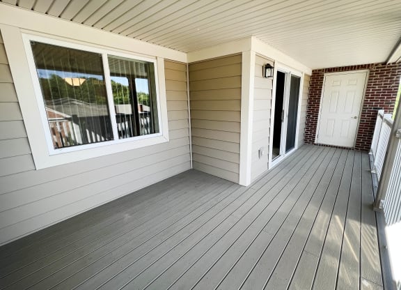 a view of the front porch of a home with white siding and a red brick wall  at The Overlook at Ft. Thomas, Ft. Thomas, KY, 41075