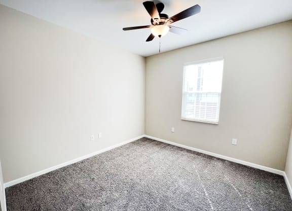 a bedroom with a ceiling fan and a window at Parkway Trails, Kentucky