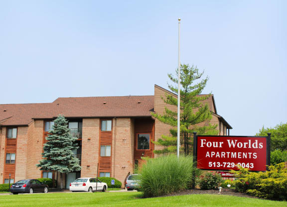 a four worlds apartments sign in front of a brick building  at Four Worlds Apartments, Cincinnati, OH