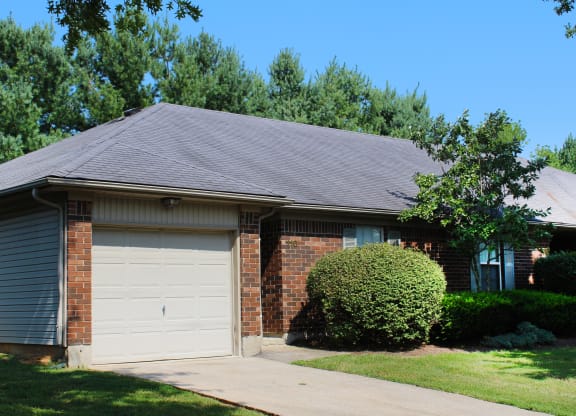 a brick house with a white garage door  at Aberdine Place, Georgetown