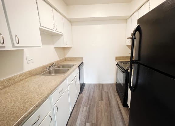 a kitchen with white cabinets and black appliances  at Hunter's Creek Apartments, Cincinnati, OH, 45242