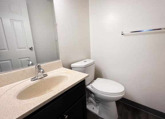 a bathroom with a sink toilet and mirror at Quail Meadow Apartments, Cincinnati, OH