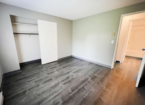 a bedroom with hardwood flooring and a closet at Quail Meadow Apartments, Cincinnati, Ohio