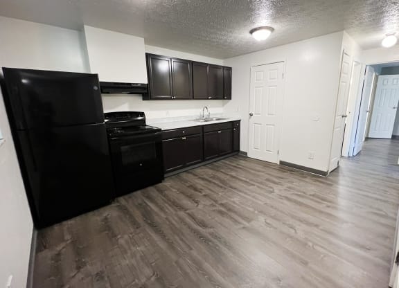 a kitchen with black appliances and white walls at Quail Meadow Apartments, Cincinnati