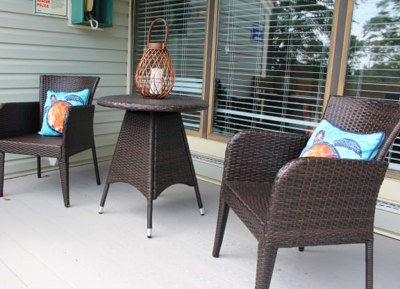 a group of chairs and a table on a porch  at Hunter's Creek Apartments, Cincinnati, Ohio