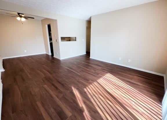 an empty living room with wood flooring in an empty house at Concord Woods Apartments, Milford, 45150