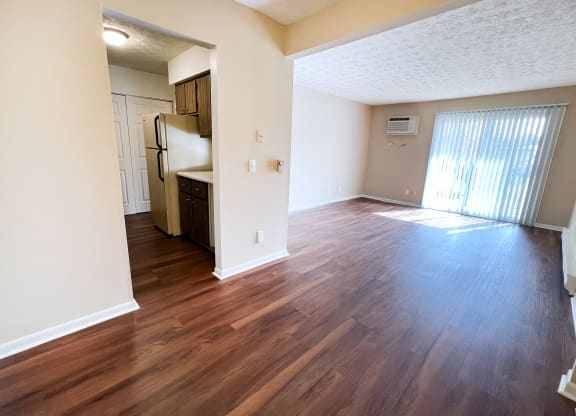 an empty living room with wood flooring in an apartment at Concord Woods Apartments, Milford, OH 45150