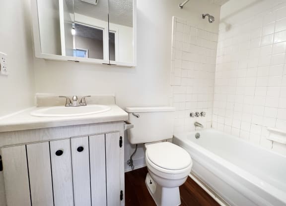 a bathroom with a sink toilet and bath tub at Concord Woods Apartments, Milford, OH