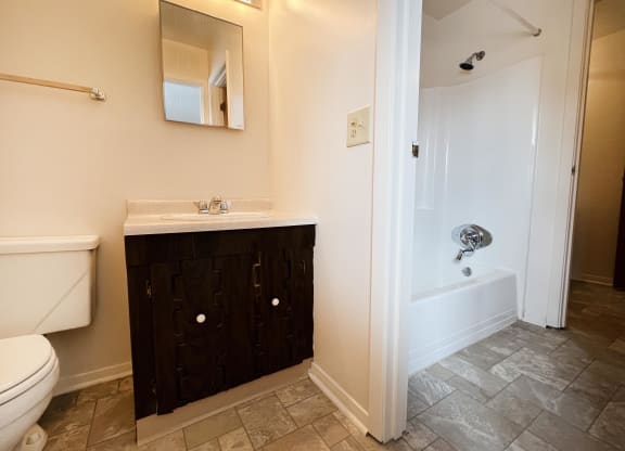 a bathroom with a toilet sink and bathtub  at Four Worlds Apartments, Cincinnati, OH