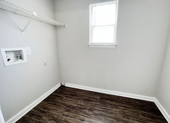 a small room with a wooden floor and a small window at 450 on Keeneland, Richmond