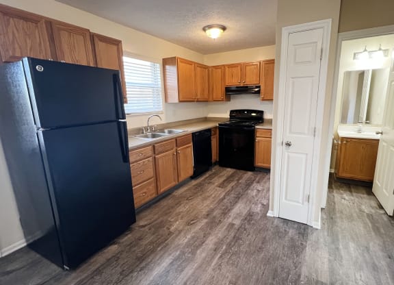 a kitchen with wood floors and a black refrigerator  at The Villas at Kingswood, West Chester, OH, 45069