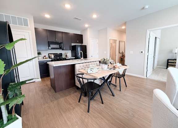 A modern kitchen with a dining table set for four.