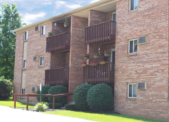 a red brick apartment building with balconies at Hunter Ridge Apartments, Cincinnati, OH
