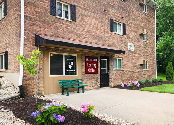 a bench sitting in front of a brick building at Hunter Ridge Apartments, Cincinnati, OH