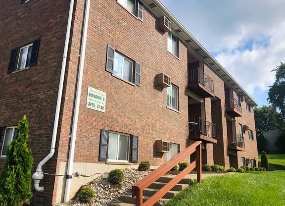 a brick building with a wooden fence in front of it at Hunter Ridge Apartments, Cincinnati, Ohio