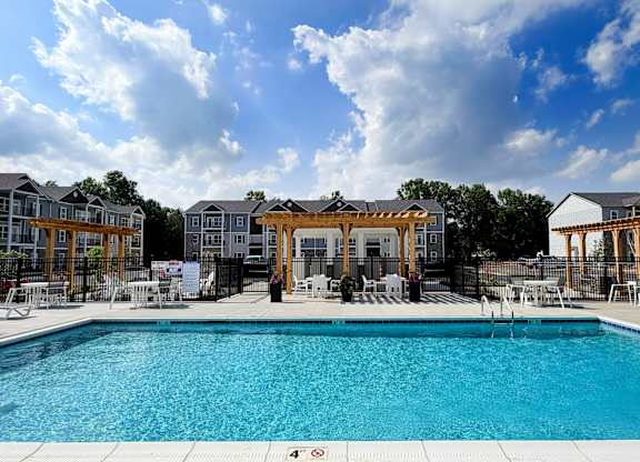 Resort style swimming pool with pergola and lounge furniture at The Meridian on 32 Apartments, Ohio