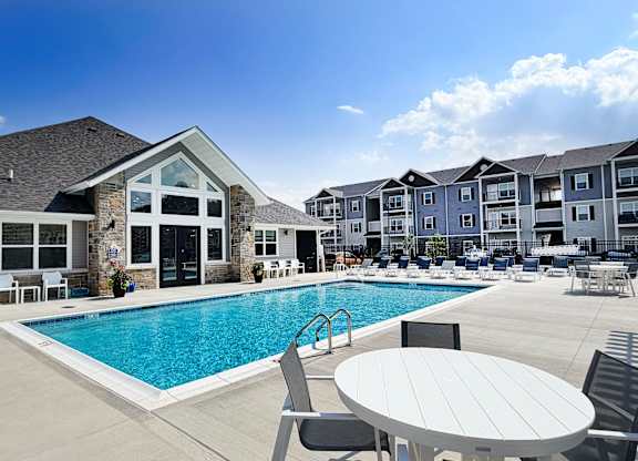Swimming pool with clubhouse and apartment buildings at The Meridian on 32 Apartments, Batavia, OH