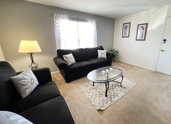 a living room with couches and a glass coffee tableat Revere Village Apartments, Centerville, 45458