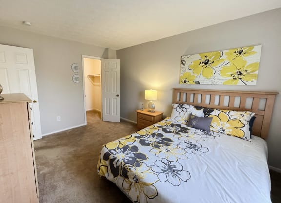 a bedroom with a bed and a door to a bathroomat Revere Village Apartments, Ohio, 45458