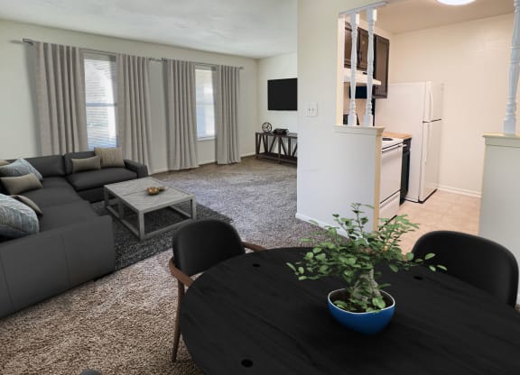 a living room with a table and a couch and a kitchenat Revere Village Apartments, Centerville
