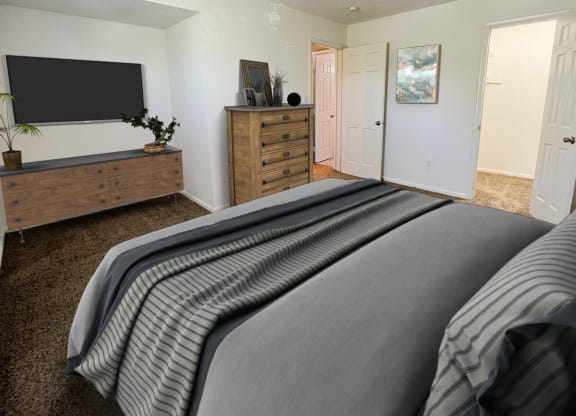 the master bedroom has a large bed and a tvat Revere Village Apartments, Ohio, 45458