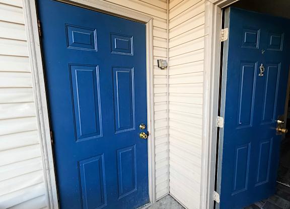 A blue door with a keyhole and a doorknob.