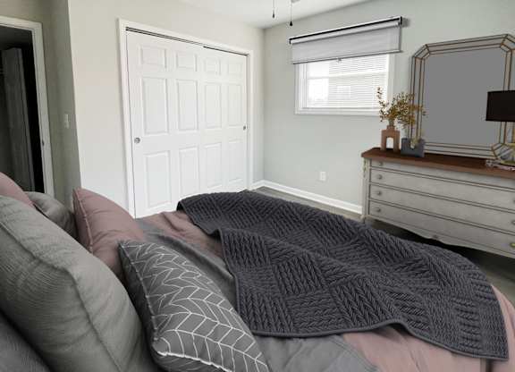 a bedroom with a bed with pillows and a dresser