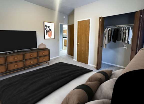 A bedroom with a large bed and a TV.