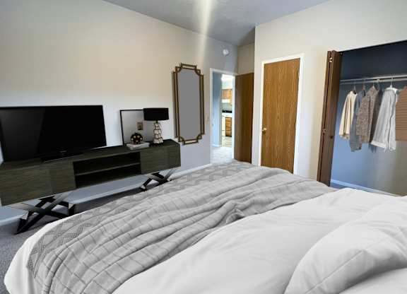 A bedroom with a large bed and a television.