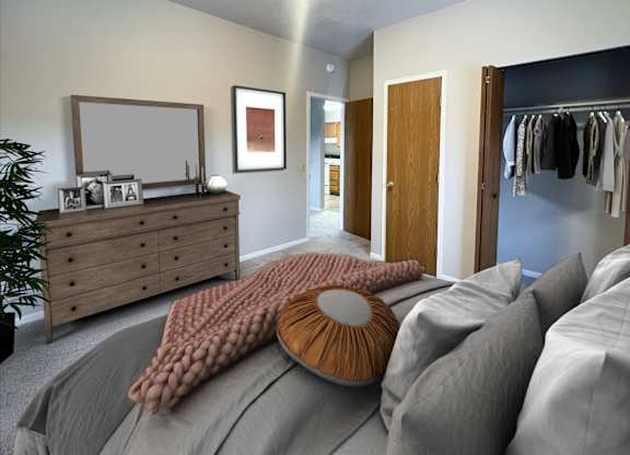 A bedroom with a bed, dresser, and a mirror.