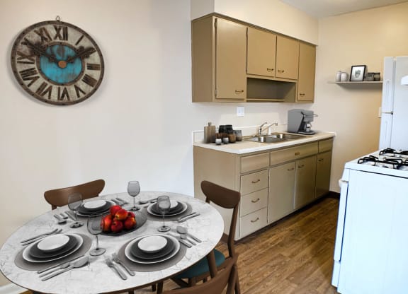 Kitchen with white appliances and dining at Sharondale Woods Apartments, Ohio