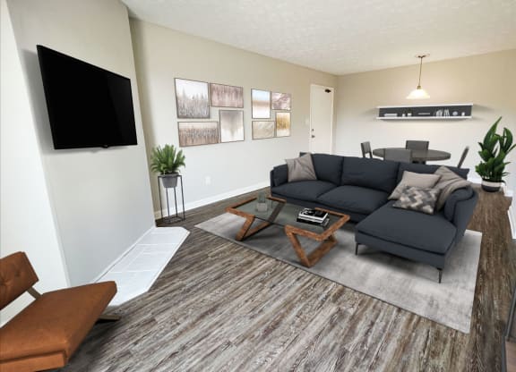 an open living room with a couch and a tv at 450 on Keeneland Apartments, Richmond, KY