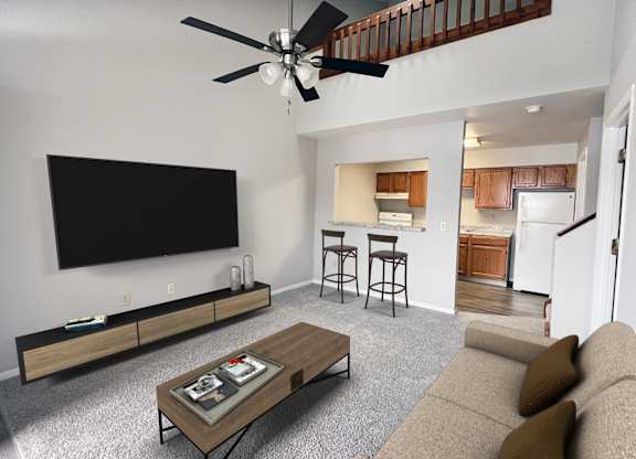 A living room with a couch, a coffee table, and a television.