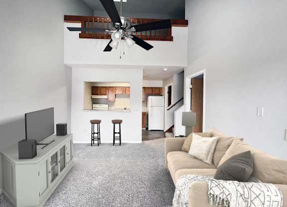 A living room with a television, a couch, and a ceiling fan.