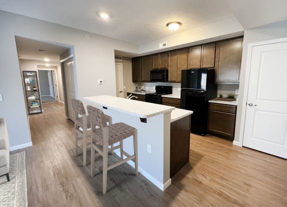 an open kitchen and dining area with a white counter top at Brookfield Village in Grove City