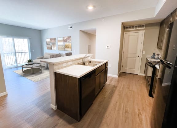an open kitchen and living room with a couch at Brookfield Village in Grove City 43123