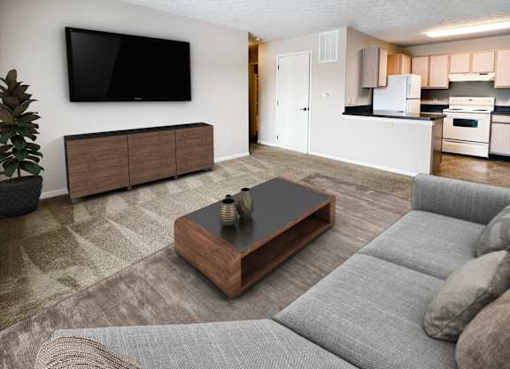 A living room with a grey couch and a wooden coffee table.