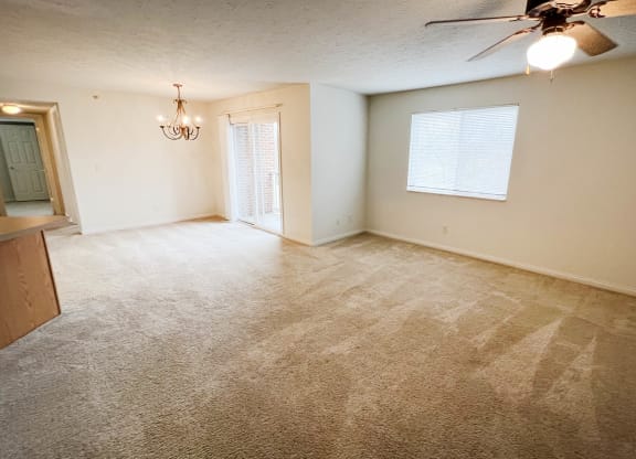 an empty living room with carpet and a ceiling fan  at Walton Ridge Apartments, Walton, KY