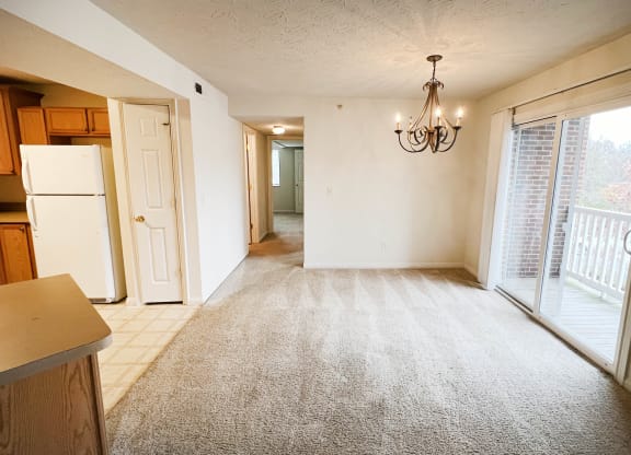 an empty kitchen and living room with a door to a balcony  at Walton Ridge Apartments, Kentucky, 41094