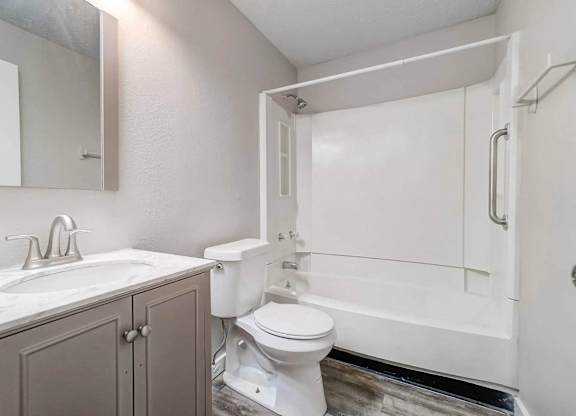 A white toilet sits next to a sink in a bathroom.