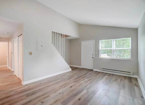 A room with wooden floors and white walls.