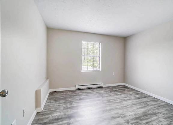 A room with a window and a door.